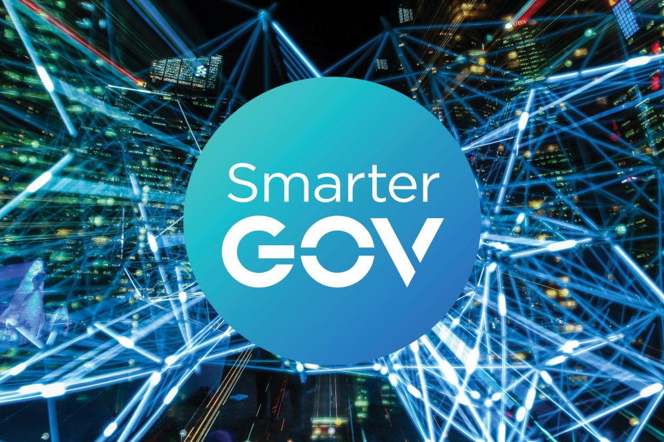 Image of smarter gov logo, with background of skyscrapers and lines indicating the transfer of data