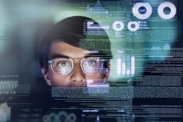 Woman looking at screen with coding on